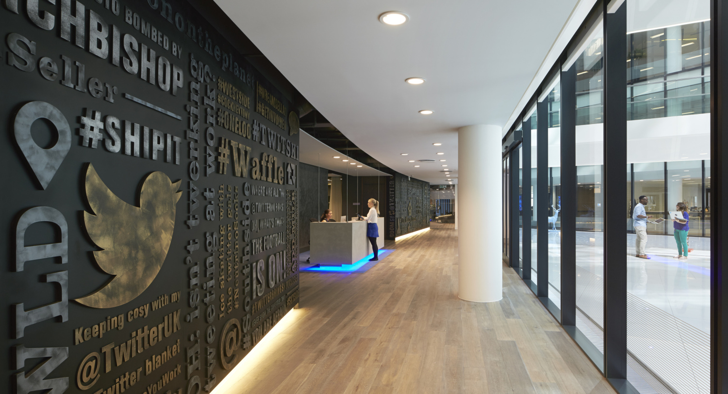 08TWTU_0001_OPA_N5_medium Wall with Twitter bird logo, reception desk beyond.