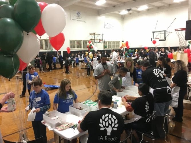 We Care Seattle In Seattle, an IA Reach team makes snowy jars with children at a We Care event.