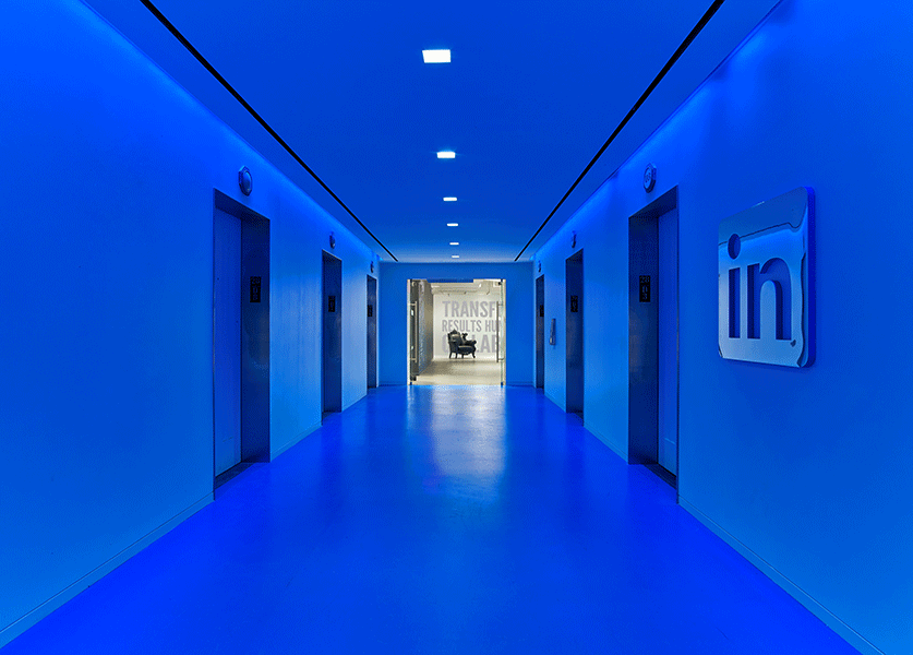 An elevator well glows with iconic LinkedIn blue in New York, signifying brand from any entry point. Photo by Eric Laignel.