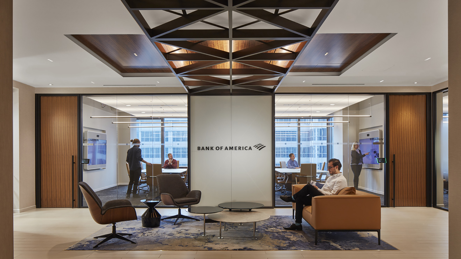 Outside of a meeting space, a Bank of America employee waits for a pending event.