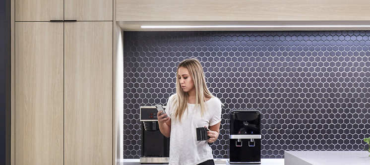 An employee checking her mobile phone in the workplace