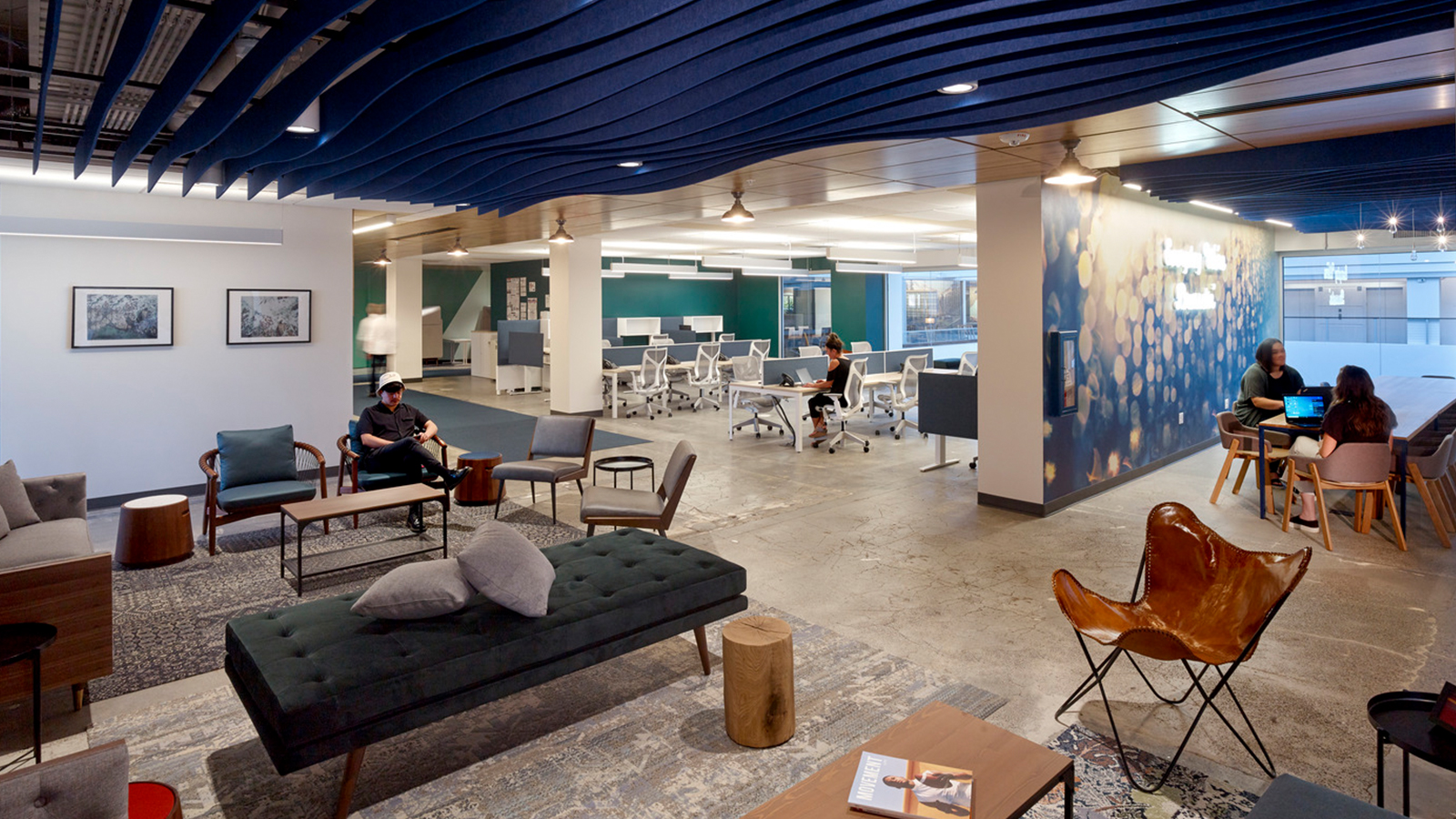 Rugs and furniture at huddle areas adjacent to the Whole Foods Seattle open work space.