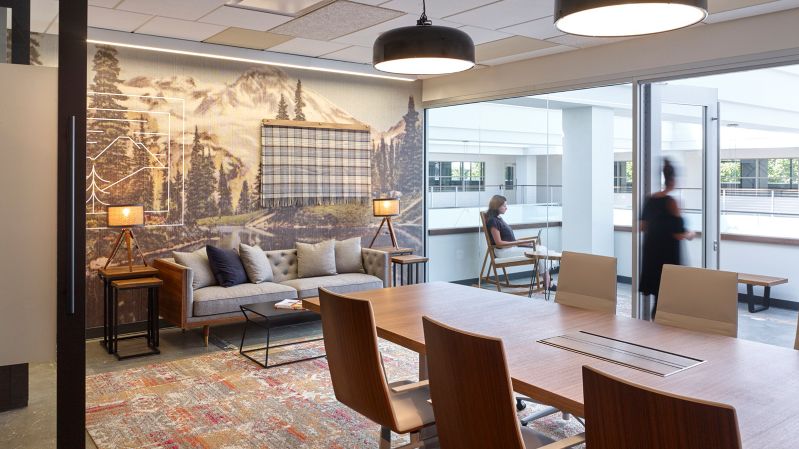 The Seattle offices of Whole Foods show a knit blanket in front of a wallpapered mountain landscape.