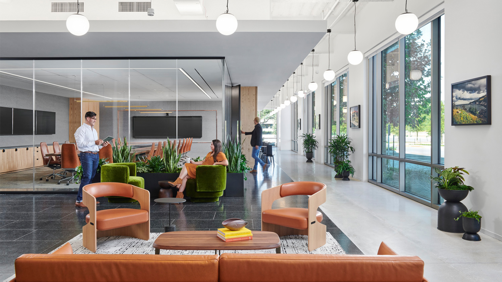 A conference room sits adjacent to an open seating area