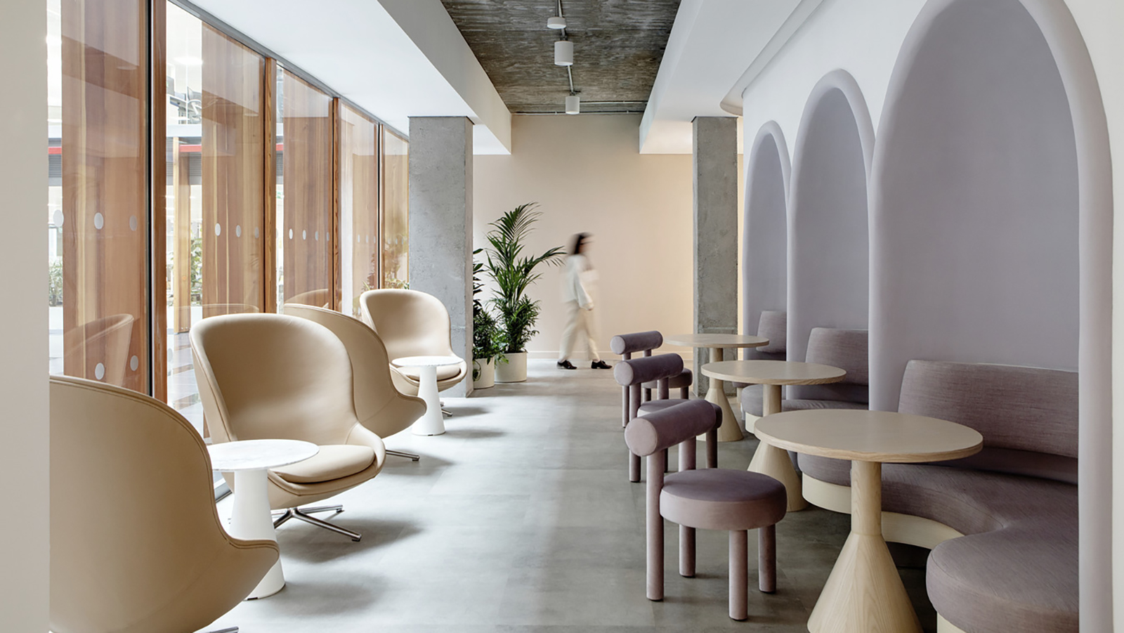 The halls in Dropbox's Dublin offices feature nooks with comfortable pink seats, partnered with open beige armchairs.